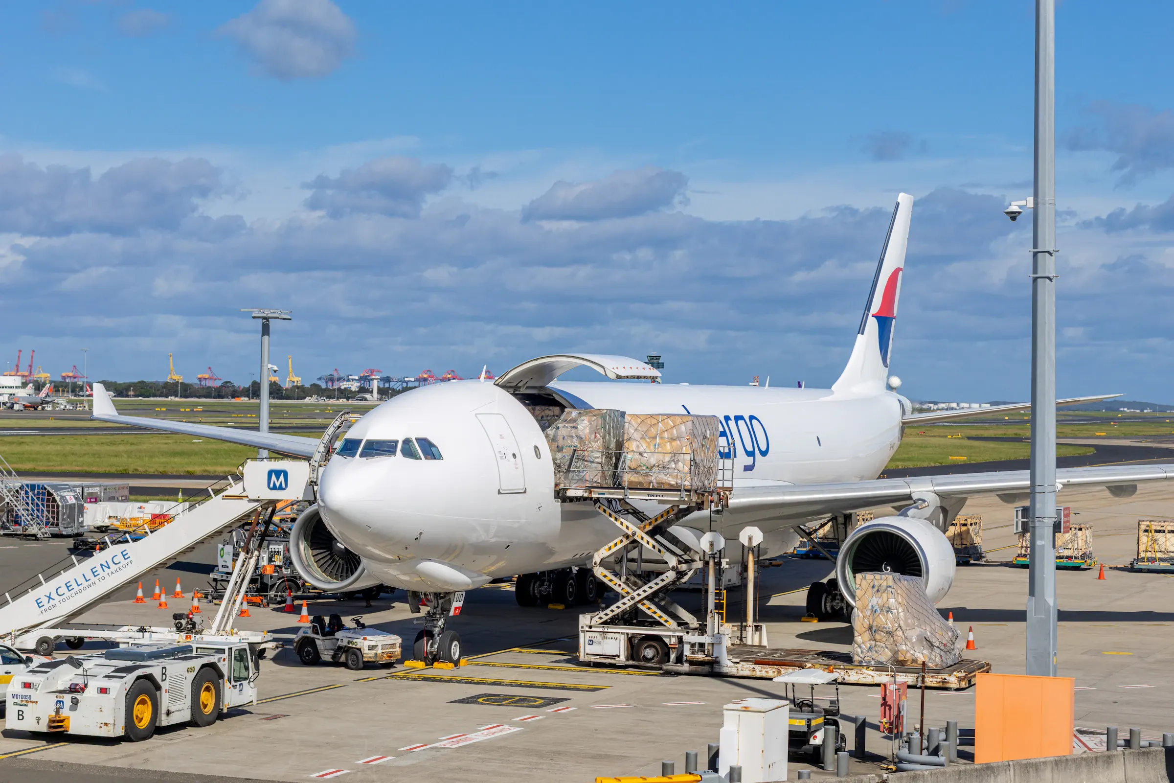 Cargo aircraft being loaded with freight on the airport tarmac